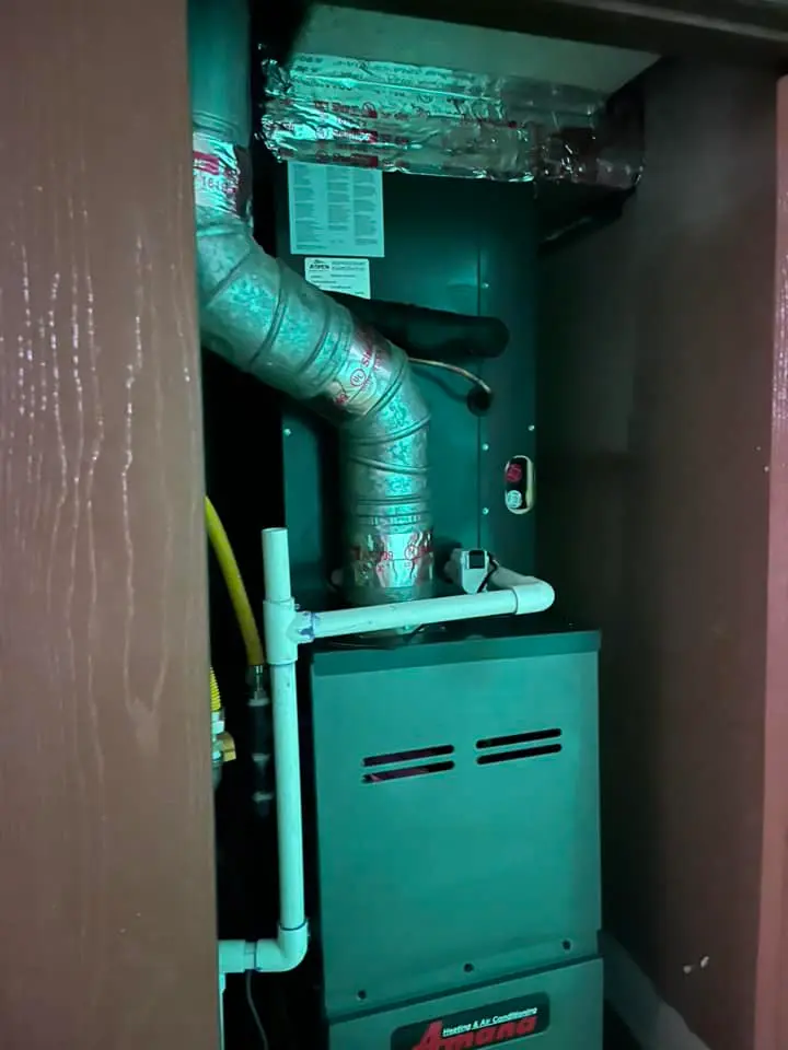 Professional closet furnace installation showing proper ventilation and combustion air supply