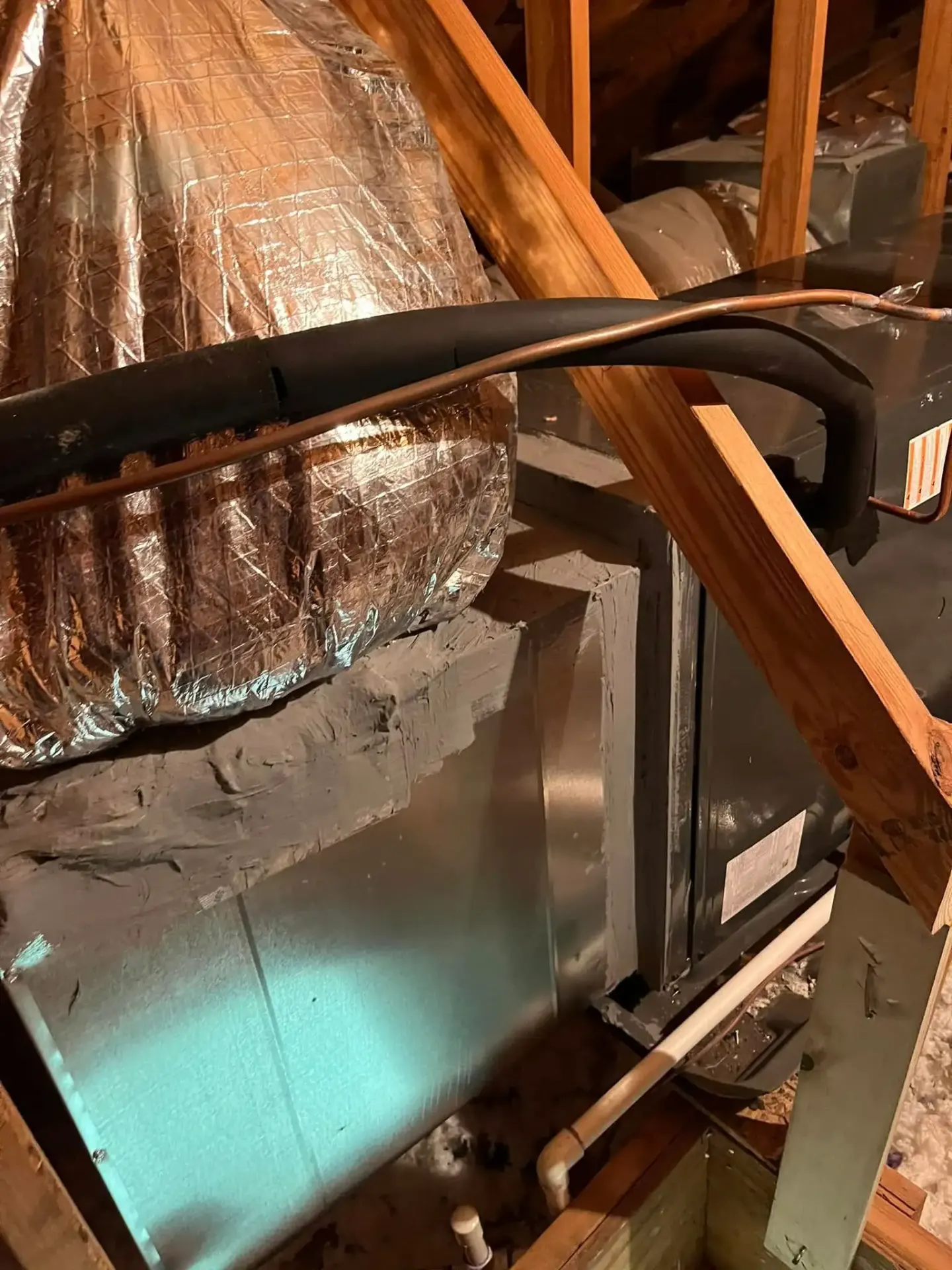 Detailed view of attic ductwork showing insulated ducts that require regular cleaning for optimal air quality